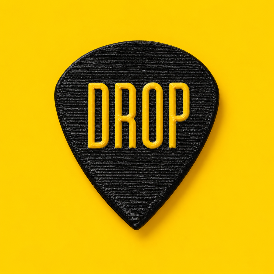 Black DROP guitar pick with raised yellow logo on a yellow background
